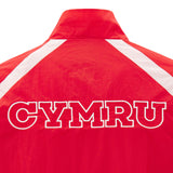 The Wales WRU 26/27 Heritage Retro Jacket by Macron is a classic red rugby jacket with white shoulder stripes and bold “CYMRU” lettering on the back, inspired by vintage Wales WRU designs.