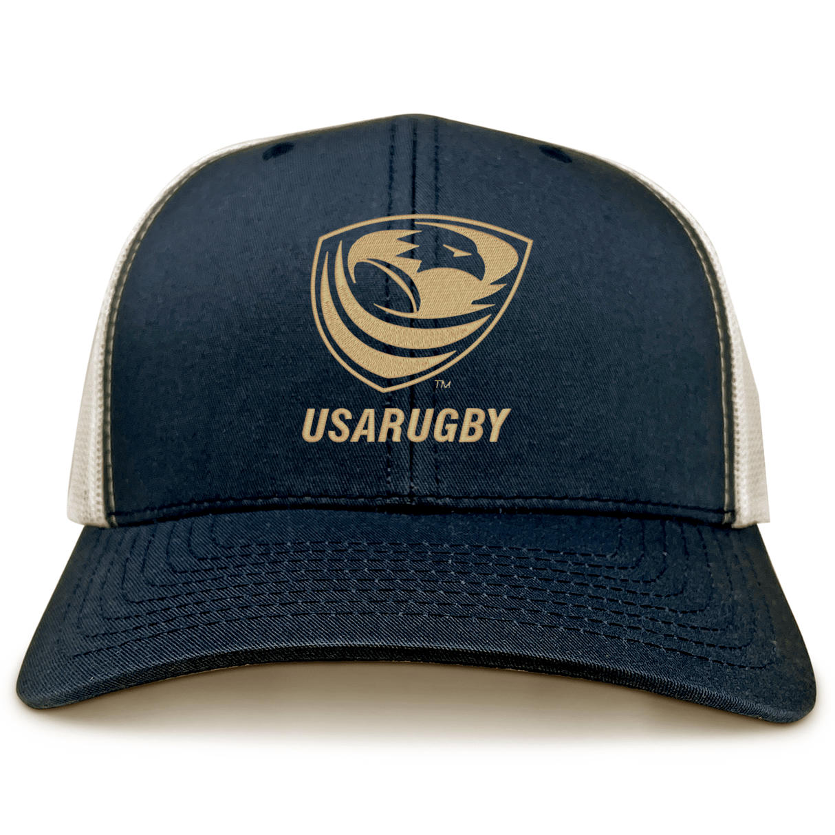 The USA Rugby Bronze Eco Trucker Hat by EMB S&S Activewear features navy blue and white organic cotton with the USA Rugby logo and "USARUGBY" printed on the front.