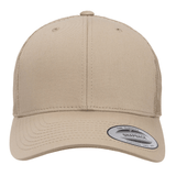 A tan S&S Activewear Retro Trucker Cap with a snapback closure, curved brim, and a sticker label on the bill, shown from the front.