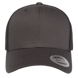 Front view of the S&S Activewear Retro Trucker Cap with a plain black front, mesh back, round brim sticker, and classic snapback closure.