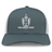 The Highlanders Rugby NC Retro Trucker Cap by EMB S&S Activewear features a gray and white design with an embroidered shield and sword logo above "HIGHLANDERS RUGBY" on the front and a snapback closure for a classic fit.