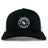 The Mudsock Rugby Retro Trucker Cap by EMB S&S Activewear features a black and white design, circular “Mudsock Youth Rugby” embroidery with a rugby ball and red-blue stripes, plus an adjustable snapback closure.