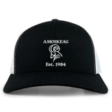 The Amoskeag Rugby Club Retro Trucker Cap by EMB S&S Activewear features black and white panels, an embroidered "AMOSKEAG," bold ram logo, "Est. 1984," and a classic snapback closure.