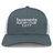 Introducing the Hornets Rugby Club 1977 Retro Trucker Cap by EMB S&S Activewear—a gray and white cap showcasing a bold, embroidered "hornets RUGBY CLUB 1977" design on the front panel. Designed with an adjustable snapback closure to ensure a comfortable fit.