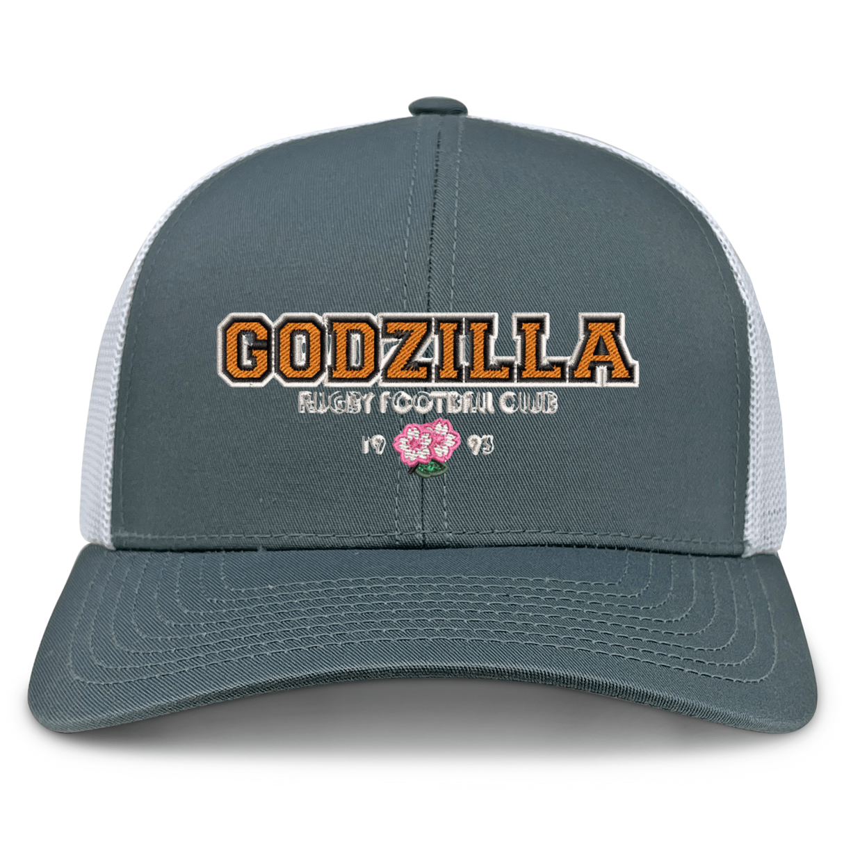 The Godzilla Rugby Football Club Retro Trucker Cap by EMB S&S Activewear features a gray and white mesh design with an embroidered “GODZILLA RUGBY FOOTBALL CLUB 1993” and a pink flower on the front.