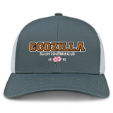 The Godzilla Rugby Football Club Retro Trucker Cap by EMB S&S Activewear features a gray and white mesh design with an embroidered “GODZILLA RUGBY FOOTBALL CLUB 1993” and a pink flower on the front.