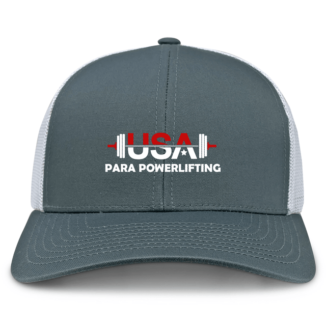 The EMB S&S Activewear USA Para Powerlifting Retro Trucker Cap features gray and white panels, embroidered "USA Para Powerlifting" text, a red and white barbell graphic on the front, and a snapback closure for adjustable fit.