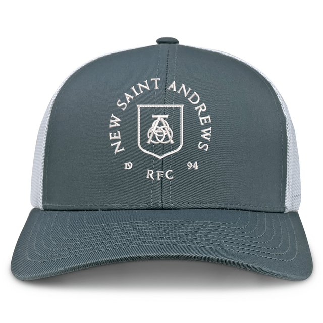 The New Saint Andrews College Retro Trucker Cap by EMB S&S Activewear features a gray and white design with “New Saint Andrews REC 1994” and a white crest logo printed on the front panel, finished with a classic snapback closure for an adjustable fit.