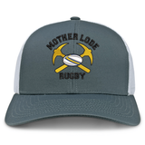 Mother Lode Retro Trucker Cap in gray with a white mesh back, featuring an embroidered logo of two crossed yellow pickaxes, a rugby ball, and the text “MOTHER LODE RUGBY.”