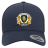 The Old Man Rivah Rugby Retro Trucker Cap by EMB S&S Activewear is a navy snapback hat with an embroidered crest, gold lions, "OLD MAN RIVAH," "MOR QUAM CEDERE," and a classic adjustable snapback closure.
