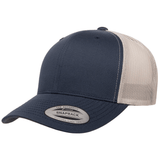 The S&S Activewear Retro Trucker Cap features a navy blue and beige design, mesh back, snapback closure, and a "Snapback" sticker on the brim.