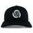 The Missoula All-Maggots Retro Trucker Cap by EMB S&S Activewear is a black and white trucker cap with an embroidered spiral seashell design in white on the front panel, featuring an adjustable snapback closure for a comfortable fit.