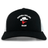 The Ventura Outlaws Rugby Retro Trucker Cap by EMB S&S Activewear is a black and white cap featuring "Ventura Outlaws Rugby" with a cowboy hat and red bandana logo, plus an adjustable snapback closure.