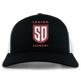Legion Academy Retro Trucker Cap in black and white featuring an embroidered red and white “Legion Academy SD” shield emblem on the front with a snapback closure.