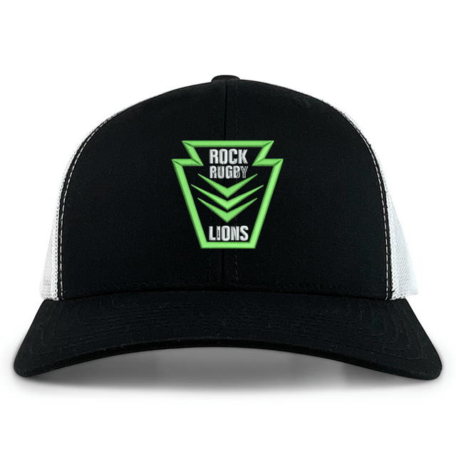 Rock Rugby Retro Trucker Cap in black and white with a green and black embroidered crest on the front reading “ROCK RUGBY LIONS.”
