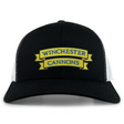 The Winchester Cannons Retro Trucker Cap by EMB S&S Activewear features a black and white design, yellow and blue embroidered front logo, and an adjustable snapback closure.
