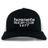 The Hornets Rugby Club 1977 Retro Trucker Cap by EMB S&S Activewear features an embroidered "hornets RUGBY CLUB 1977" design on the front, classic black and white color styling, and a comfortable snapback closure for an adjustable fit.