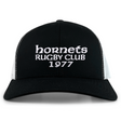 The Hornets Rugby Club 1977 Retro Trucker Cap by EMB S&S Activewear features an embroidered "hornets RUGBY CLUB 1977" design on the front, classic black and white color styling, and a comfortable snapback closure for an adjustable fit.