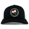 The Society of Iowa Rugby Referees Retro Trucker Cap by EMB S&S Activewear features a black and white design with a circular front logo adorned with pink flowers, embroidered on the front panel. The cap also includes an adjustable snapback closure for a comfortable fit.