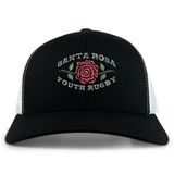 The EMB S&S Activewear Santa Rosa Youth Rugby Retro Trucker Cap is a black and white trucker cap with a red rose and green leaves, featuring “Santa Rosa Youth Rugby” embroidered on the front.