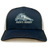 University of New Hampshire Retro Trucker Cap in navy blue and white, featuring an embroidered wildcat logo and “MEN’S RUGBY” text on the front.