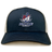 SUNY Maritime Men’s Rugby Retro Trucker Cap in navy blue with a white mesh back, snapback closure, and an embroidered Maritime Rugby logo of a stylized M and anchor on the front.