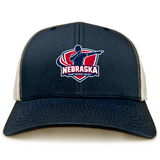 The EMB S&S Activewear Nebraska Rugby Referee Society Retro Trucker Cap features a navy and beige design, an embroidered referee logo on the front panel, and a snapback closure for adjustable fit.