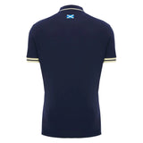 The Scotland SRU 26/27 Travel Polo by Macron is shown from the back, displaying a small Scottish flag below the collar and subtle light stripes on the sleeve edges.