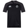 Missoula All-Maggots Vapodri Evader Jersey by EMB Canterbury: A black short-sleeved rugby jersey featuring a white EMB Canterbury logo on the right chest and a white circular Missoula All-Maggots emblem on the left chest. Designed with a subtle V-neck and crafted from moisture-wicking Vapodri fabric for comfort during intense play.