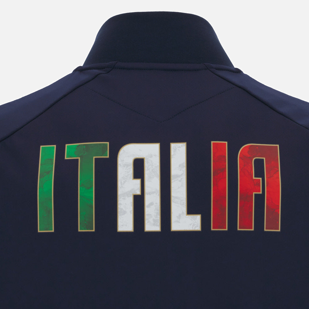 The Italy 25/26 Anthem Jacket by Macron features "ITALIA" on the back in green, white, and red, inspired by the iconic Italy Rugby anthem jacket.
