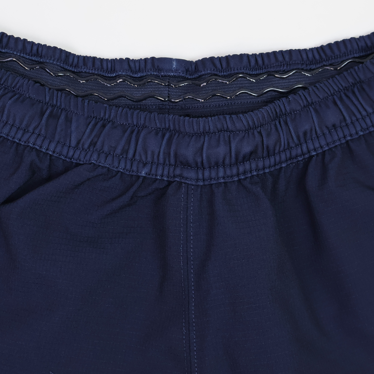 Close-up of the waistband on USA Rugby 25/26 Matchday Home Shorts by Macron, showing an elastic band with an inner wavy silicone grip.