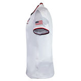 USA Rugby 24/25 Authentic Matchday Away Jersey by Macron: White short-sleeve jersey featuring a U.S. flag patch on the right sleeve, black and red trim on collar and sleeves; shown from the side against a white background.