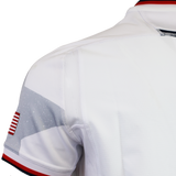 Close-up of the USA Rugby 24/25 Authentic Matchday Away Jersey by Macron, showing a small American flag patch and red, white, and blue trim on the collar and sleeve—true details of a USA Rugby jersey.