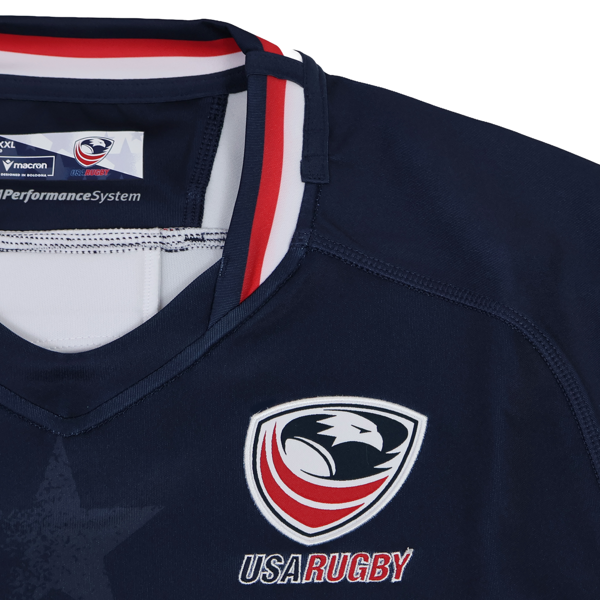Macron Women's USA Rugby 24/25 Home Bodyfit Shirt features the team logo, "USA RUGBY" text, red, white, and blue collar accents in a flattering navy Bodyfit design.