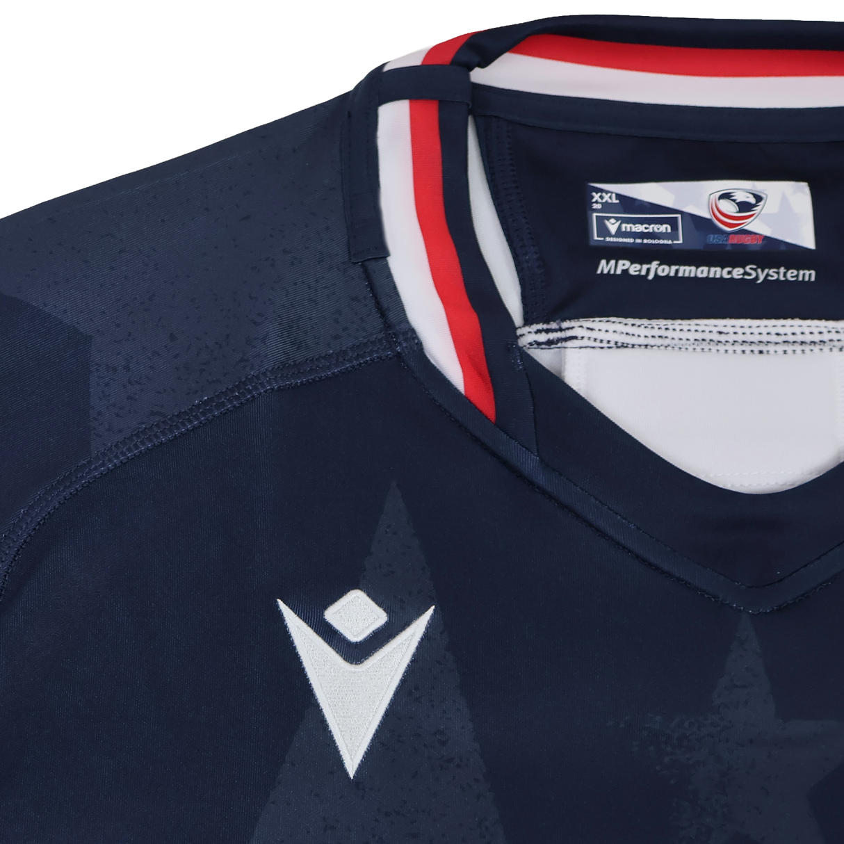 Close-up of the Women's USA Rugby 24/25 Home Bodyfit Shirt by Macron in navy blue, featuring white and red collar details, visible Macron logo, and "MPerformanceSystem" text on the collar tag.