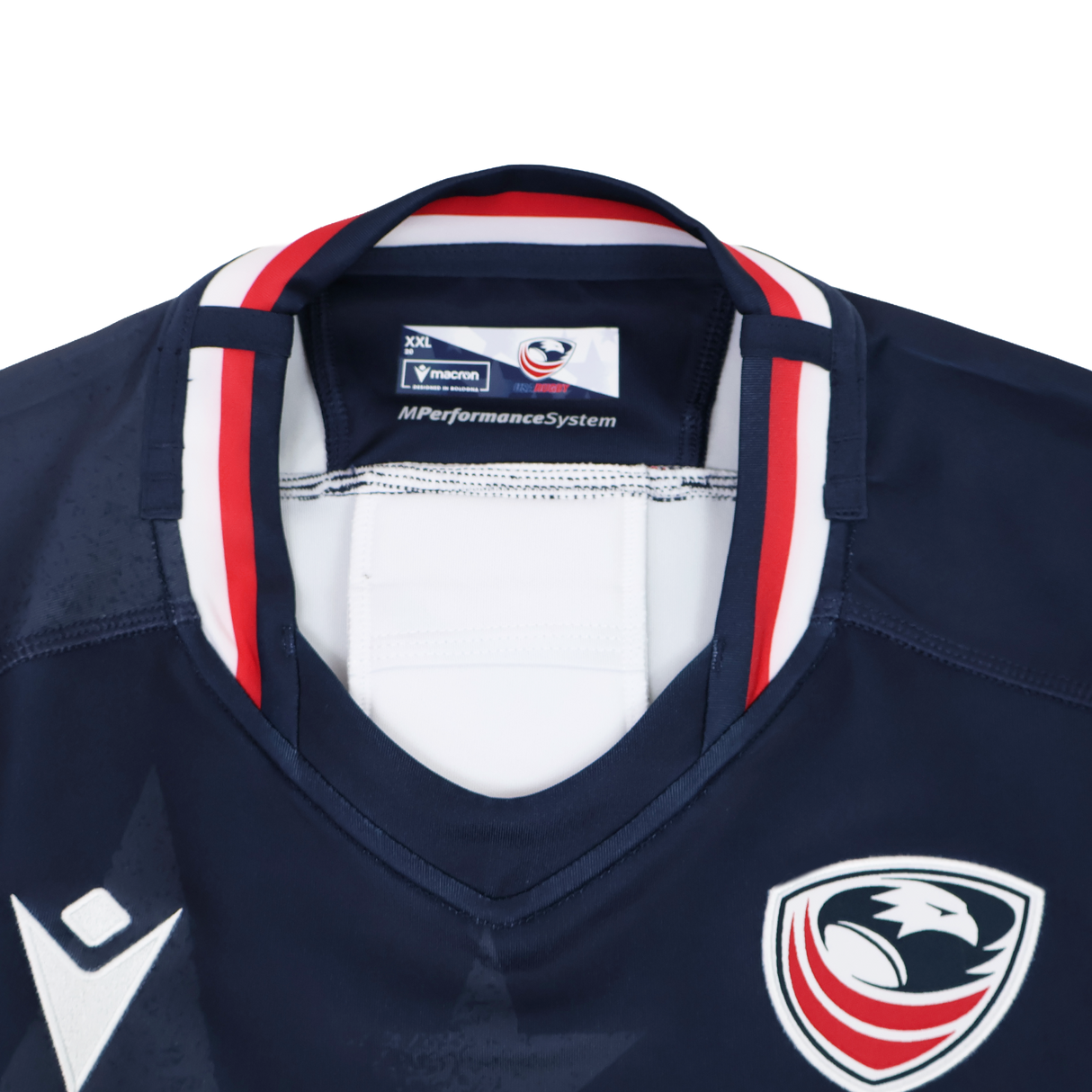Close-up of the collar and chest of the Women's USA Rugby 24/25 Home Bodyfit Shirt by Macron, in navy with red, white, and blue trim, featuring a bird logo and the Macron brand label.
