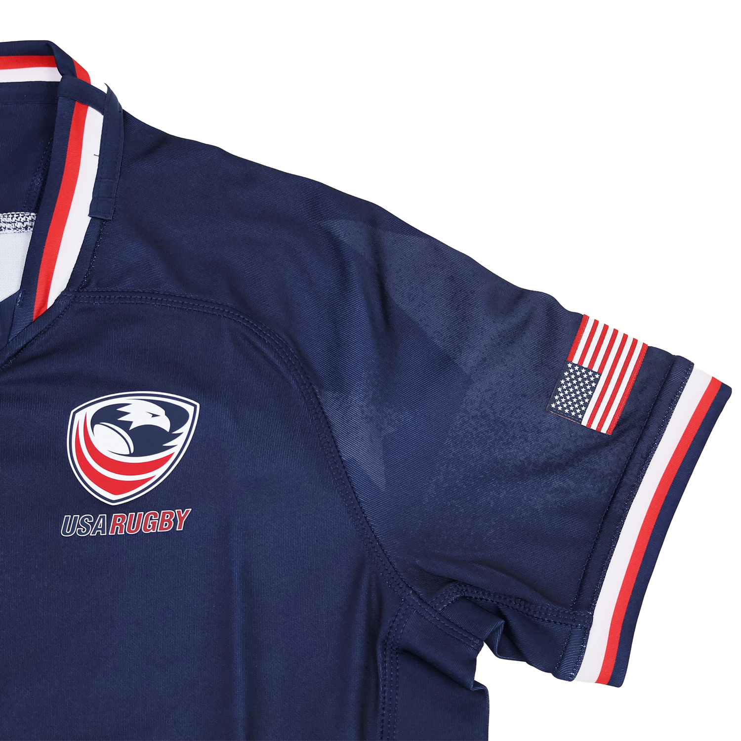 The Youth USA Rugby 24/25 Home Jersey by Macron features the team logo on the chest, an American flag patch on the sleeve, and red, white, and blue trim. A great choice for young fans to show USA Rugby pride.
