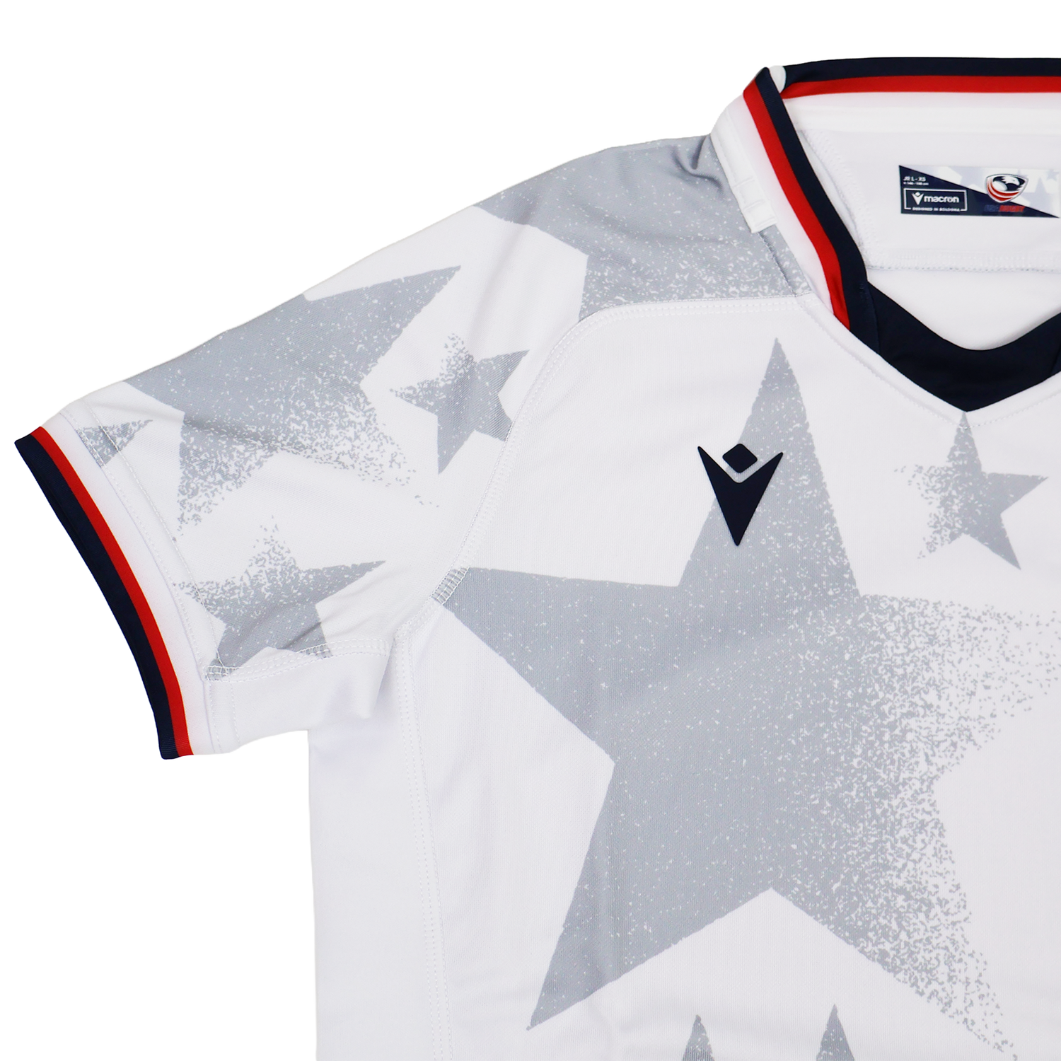 The Youth USA Rugby 24/25 Away Jersey by Macron features a white design with large gray stars, black and red collar trim, and a black Macron logo on the chest.