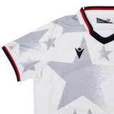 The Youth USA Rugby 24/25 Away Jersey by Macron features a white design with large gray stars, black and red collar trim, and a black Macron logo on the chest.