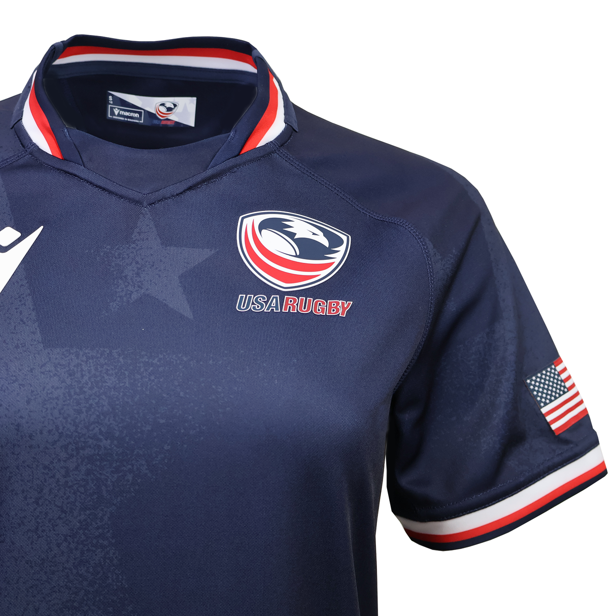 Show your pride in the Women's USA Rugby 25/26 Replica Home Jersey by Macron, featuring a navy blue design, team logo on the chest, American flag patch on the sleeve, and red, white & blue trim on collar and cuffs.