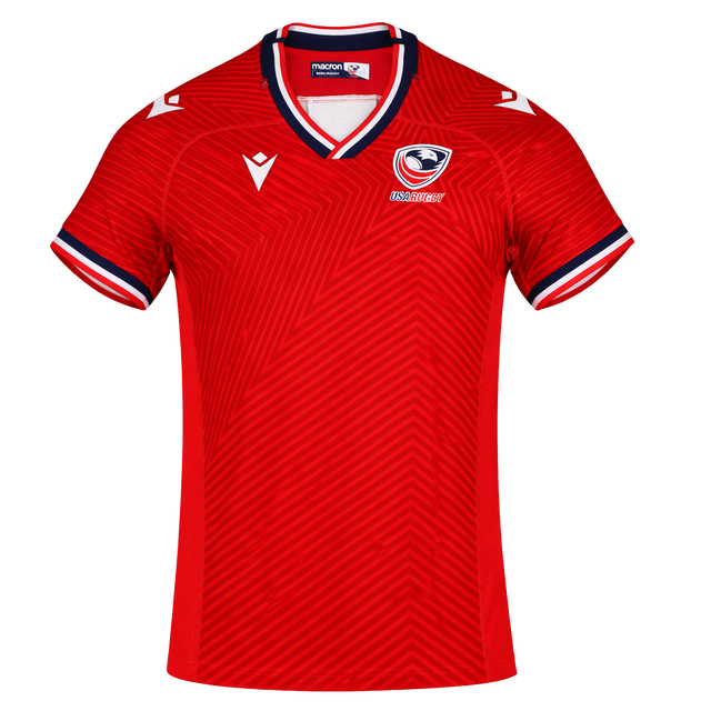 The USA Rugby 24/25 Red Replica Training Jersey by Macron features dark blue and white accents, a zigzag front pattern, and the Macron logo—ideal for fans wanting an authentic training jersey look.