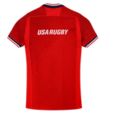 The USA Rugby 24/25 Red Replica Training Jersey by Macron features "USA RUGBY" in white on the back, dark red geometric patterns, and striped trim on the sleeves and collar.