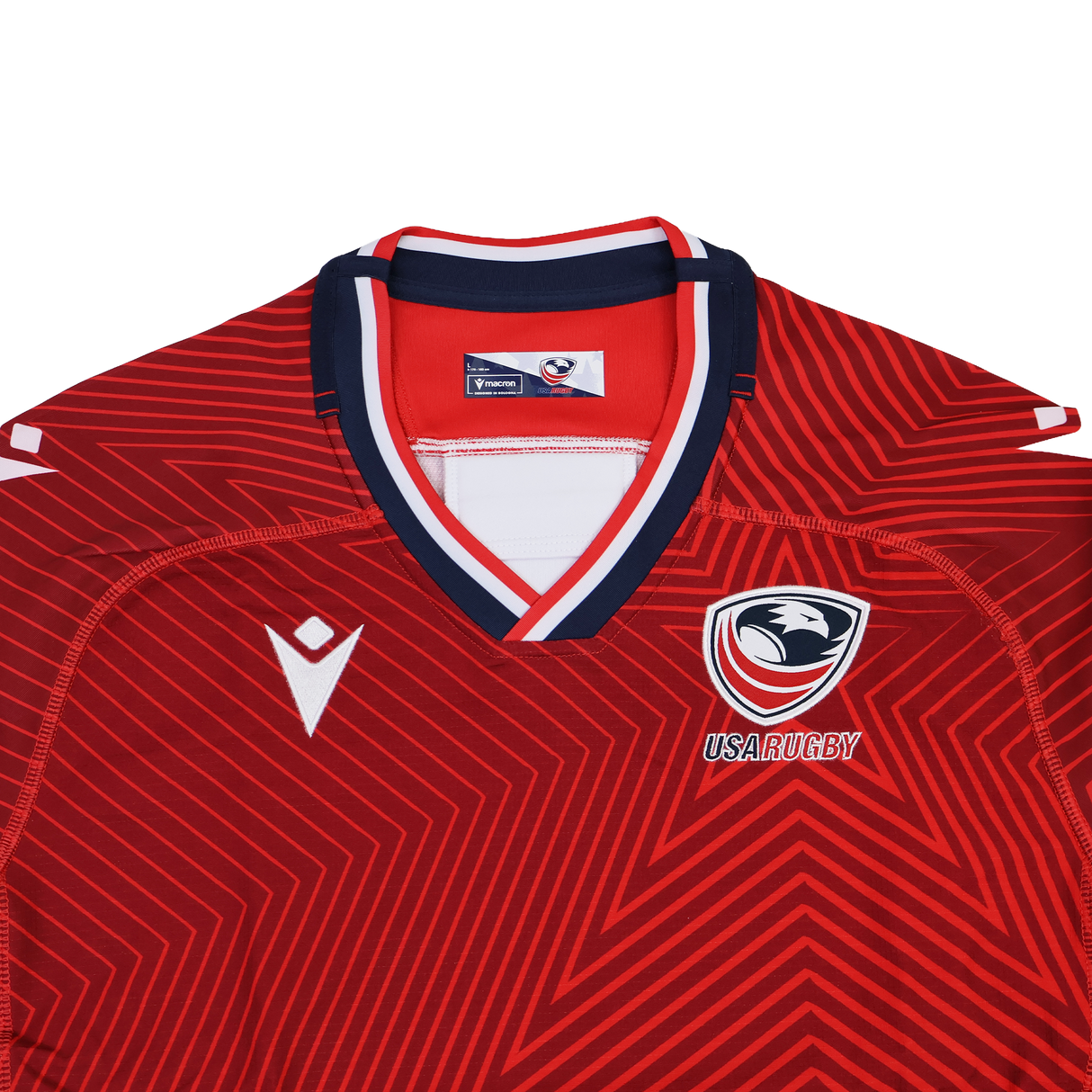 The USA Rugby 24/25 Red Replica Training Jersey by Macron features geometric patterns, a navy and white collar, the USA Rugby logo, and a white Macron logo—ideal for fans and training alike.