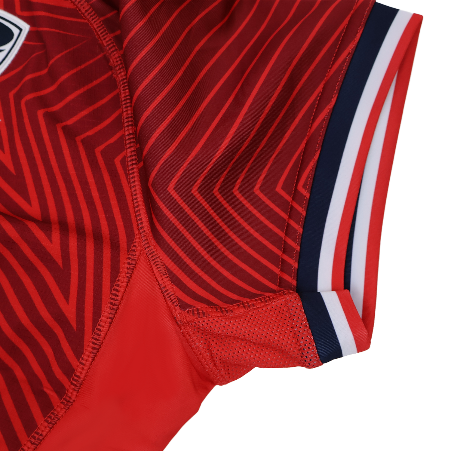 Close-up of the USA Rugby 24/25 Red Replica Training Jersey by Macron, showcasing diagonal stripes, mesh fabric detail, and navy, white, and red sleeve trim.