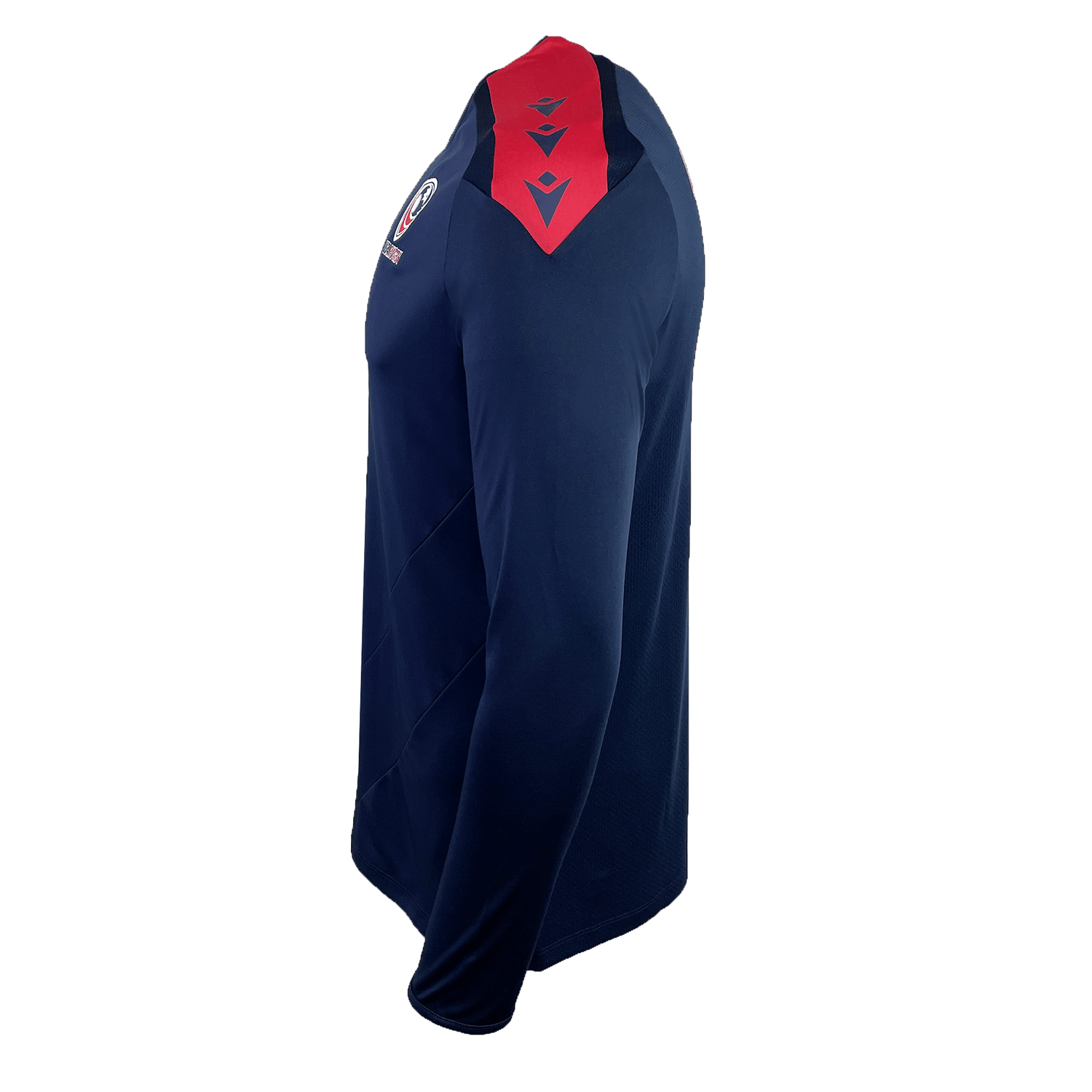 The USA Rugby 25 Player Long Sleeve Training Shirt by Macron features a navy blue design with red shoulder accents and a USA Rugby patch on the upper arm, shown against a white background.