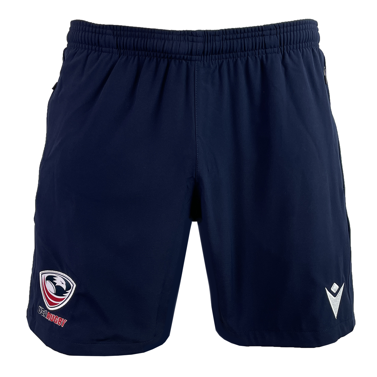 The USA Rugby 25 Player Training Shorts by Macron are navy blue with an elastic waistband, showcasing the USA Rugby team logo on the left leg and Macron's white logo on the right.