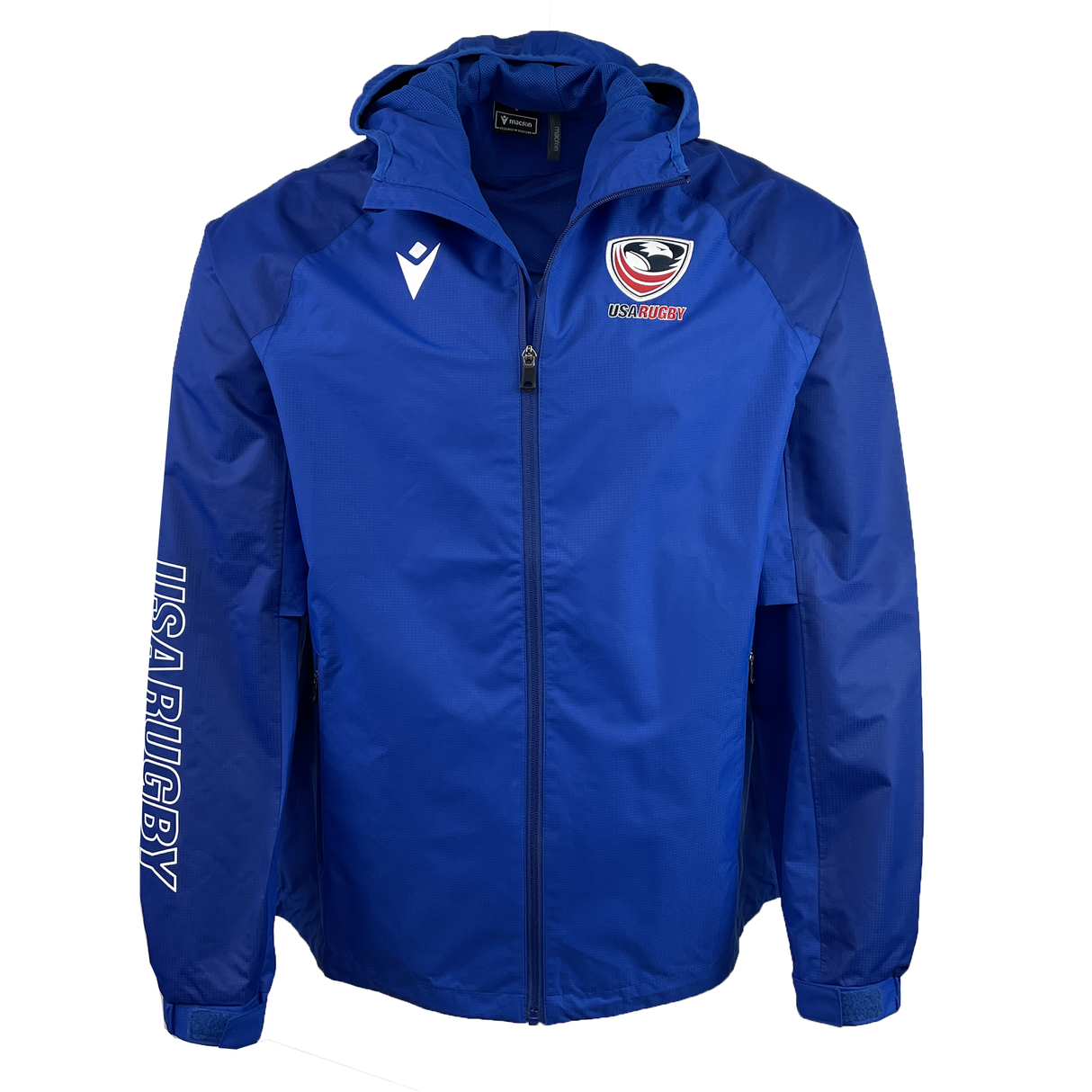 The USA Rugby 25 Player Waterproof Jacket by Macron features a blue hood, USA Rugby logo on the chest, "USA RUGBY" on the right sleeve, full front zipper, and two zippered pockets, blending style and functionality.