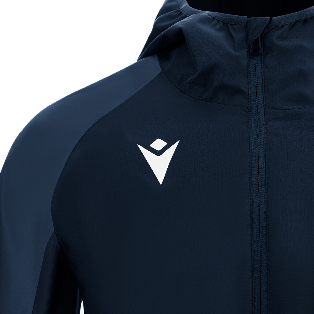 Close-up of the USA Rugby 25 Player Waterproof Jacket by Macron in navy blue, featuring a white geometric chest logo, advanced waterproof fabric, and a front zipper for maximum protection in extreme wet weather.