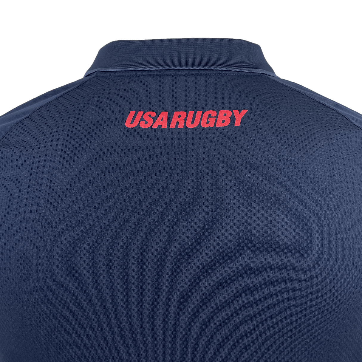 Back view of the USA Rugby 25 Travel Poly Polo by Macron in navy blue, featuring "USA RUGBY" boldly printed in red uppercase letters near the collar.