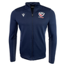 The USA Rugby 25 Travel 3D Full-Zip Top by Macron is a navy blue top with the USA Rugby 25 Travel logo on the left chest and a white Macron logo on the right.